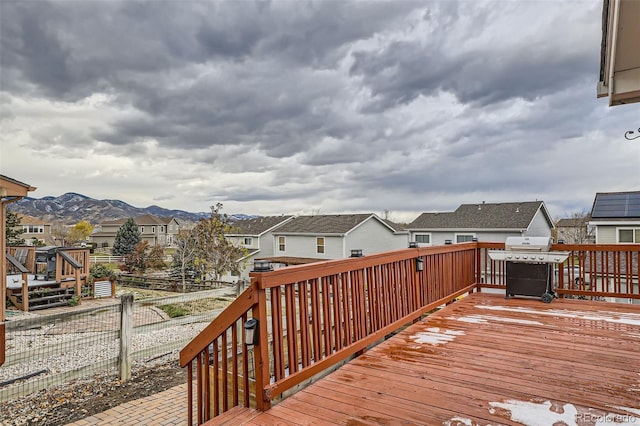 wooden deck featuring a mountain view and area for grilling