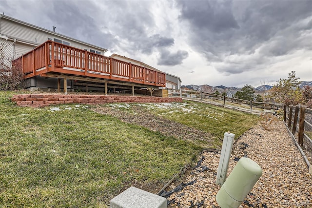 view of yard featuring a deck with mountain view