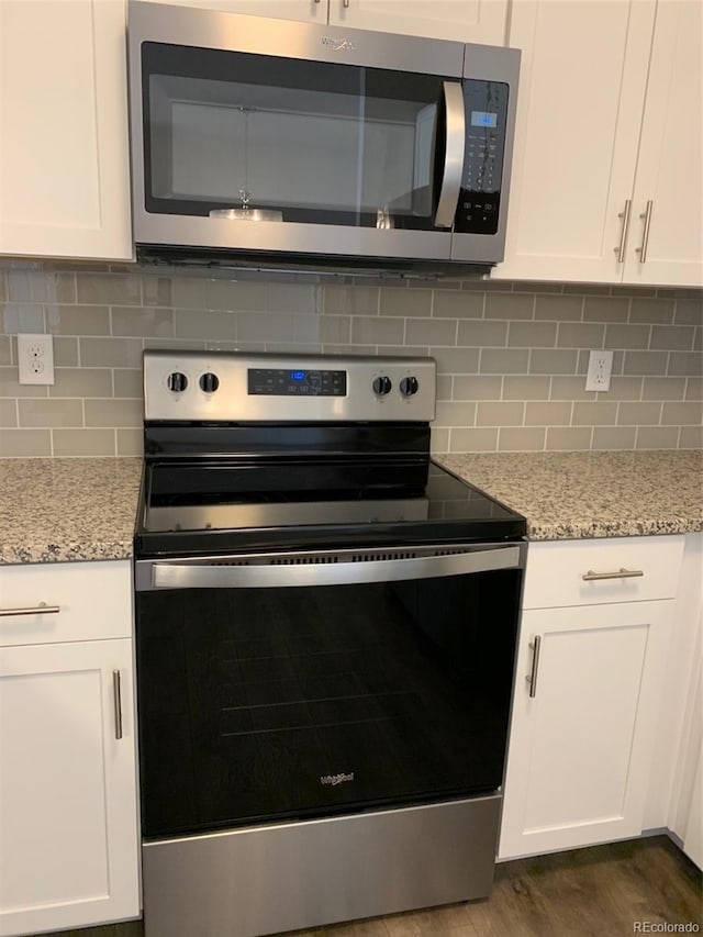 kitchen with white cabinetry, appliances with stainless steel finishes, and decorative backsplash