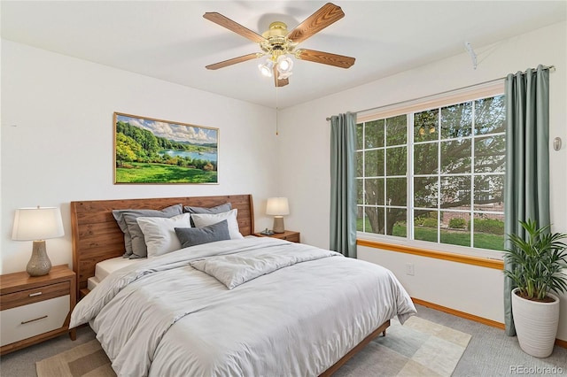 bedroom featuring light carpet and ceiling fan