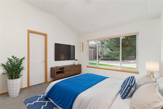 bedroom with vaulted ceiling and light colored carpet