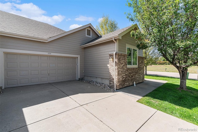 view of front of home with a garage and a front lawn