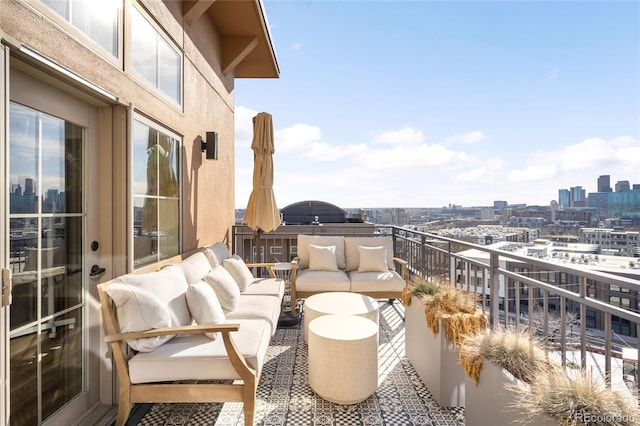 balcony featuring a city view and an outdoor hangout area