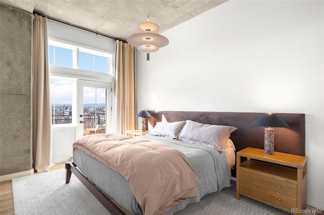 bedroom with wood finished floors and access to outside