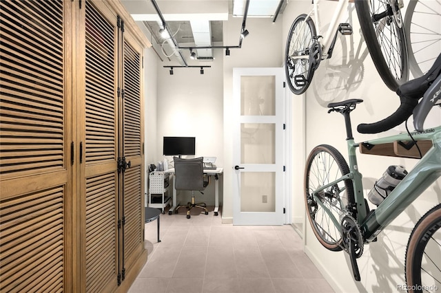 interior space featuring tile patterned floors and baseboards