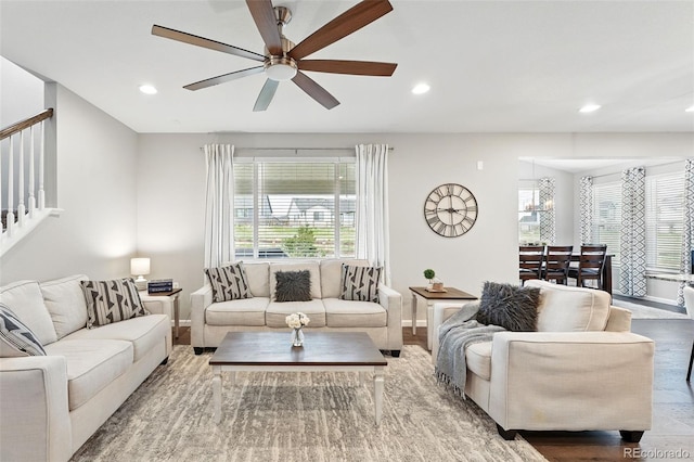 1101 E Witherspoon Dr, Elizabeth, CO 80107 - living room featuring baseboards, a healthy amount of sunlight, recessed lighting, and ceiling fan with notable chandelier