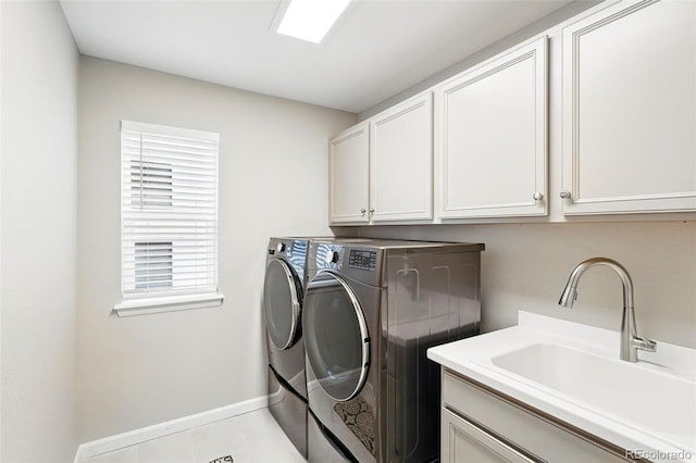 1101 E Witherspoon Dr, Elizabeth, CO 80107 - clothes washing area featuring cabinet space, washing machine and dryer, baseboards, and a sink
