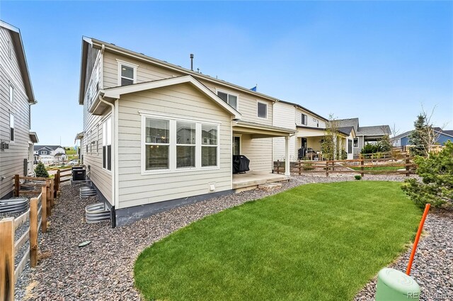 1101 E Witherspoon Dr, Elizabeth, CO 80107 - back of property with a yard, fence, a patio, and central air condition unit
