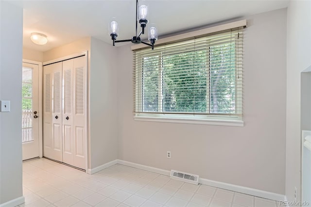 4780 W 102nd Pl, Westminster, CO 80031 - unfurnished dining area featuring healthy amount of natural light, a chandelier, and light tile patterned floors