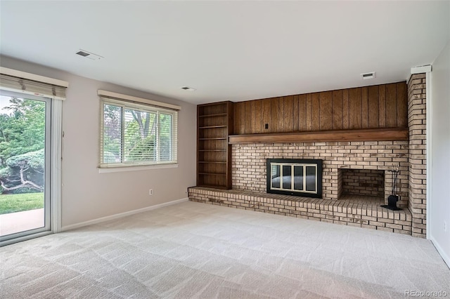 4780 W 102nd Pl, Westminster, CO 80031 - unfurnished living room featuring light colored carpet, a brick fireplace, and built in shelves