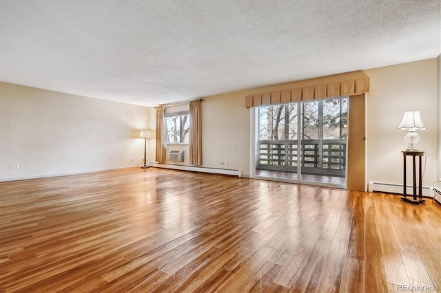 350 S Clinton St Unit 9C, Denver, CO 80247 - empty room featuring wood finished floors, a baseboard radiator, and baseboard heating