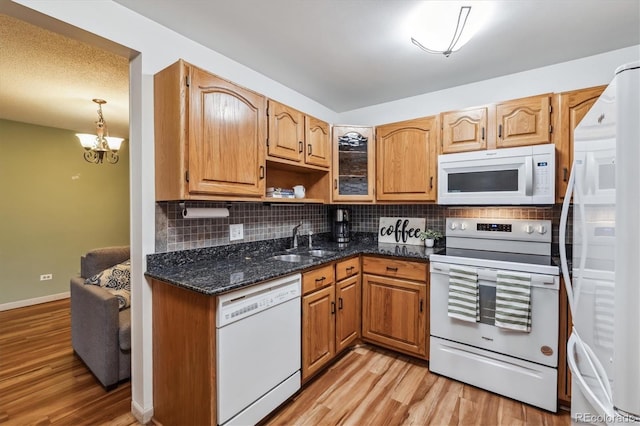 350 S Clinton St Unit 9C, Denver, CO 80247 - kitchen featuring white appliances, decorative backsplash, light wood finished floors, and a sink