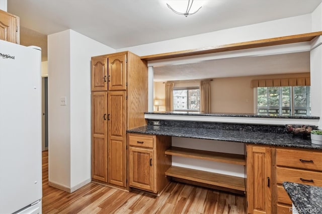350 S Clinton St Unit 9C, Denver, CO 80247 - kitchen featuring freestanding refrigerator, light wood-style flooring, healthy amount of natural light, and brown cabinetry