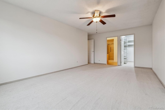 350 S Clinton St Unit 9C, Denver, CO 80247 - spare room featuring light carpet, a ceiling fan, and baseboards