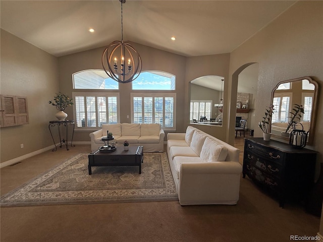carpeted living area with arched walkways, a chandelier, vaulted ceiling, and baseboards
