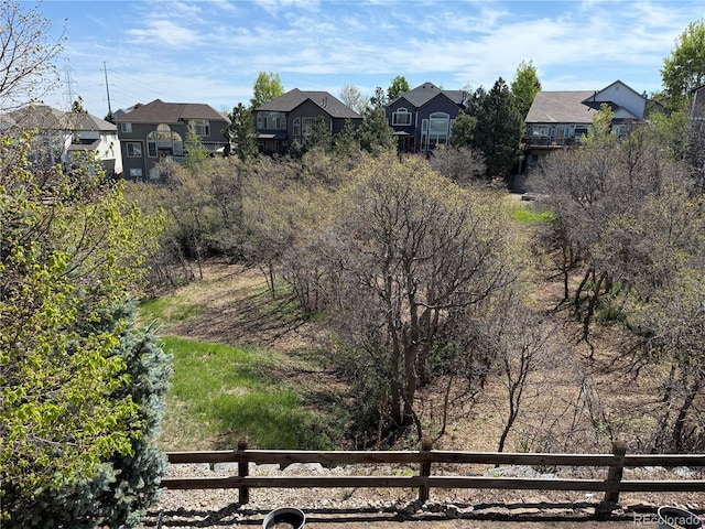 view of yard featuring fence and a residential view