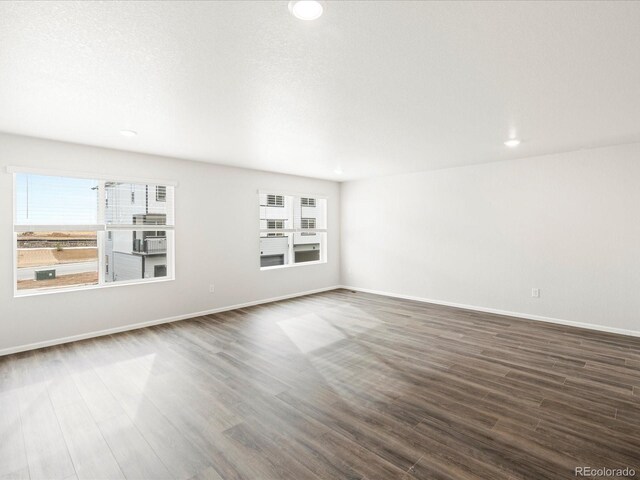 4761 Talley St, Morrison, CO 80465 - unfurnished living room with baseboards, dark wood finished floors, and recessed lighting