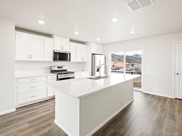 4761 Talley St, Morrison, CO 80465 - kitchen with a sink, visible vents, wood finished floors, and stainless steel appliances