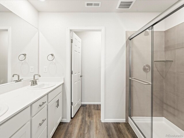 4761 Talley St, Morrison, CO 80465 - full bathroom featuring a stall shower, wood finished floors, a sink, and visible vents