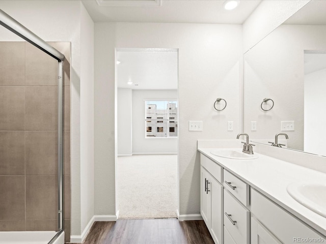 4761 Talley St, Morrison, CO 80465 - full bath featuring a shower with shower door, double vanity, a sink, and wood finished floors