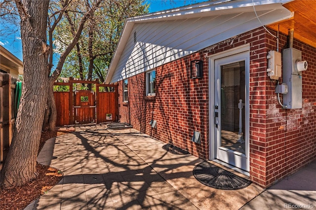 view of patio with fence and a gate