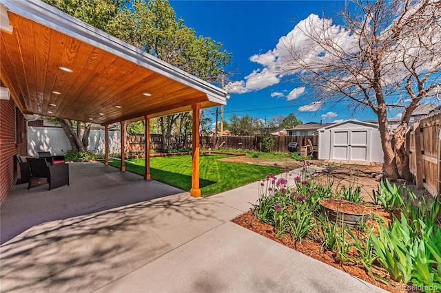 view of patio with a shed and an outbuilding