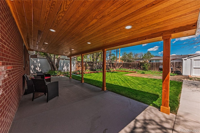 view of patio / terrace featuring a shed and an outbuilding