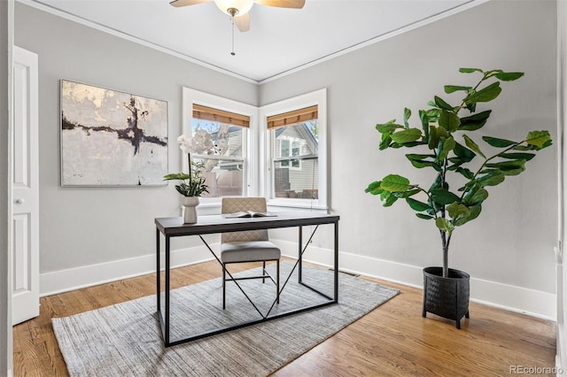 office with baseboards, wood finished floors, a ceiling fan, and ornamental molding