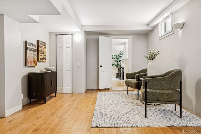 living area with baseboards and light wood-type flooring