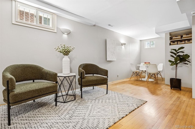 sitting room featuring visible vents and hardwood / wood-style flooring