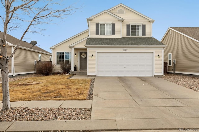 traditional-style home with a garage, roof with shingles, and driveway