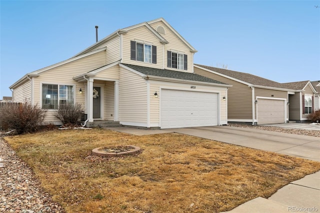 traditional-style house featuring concrete driveway