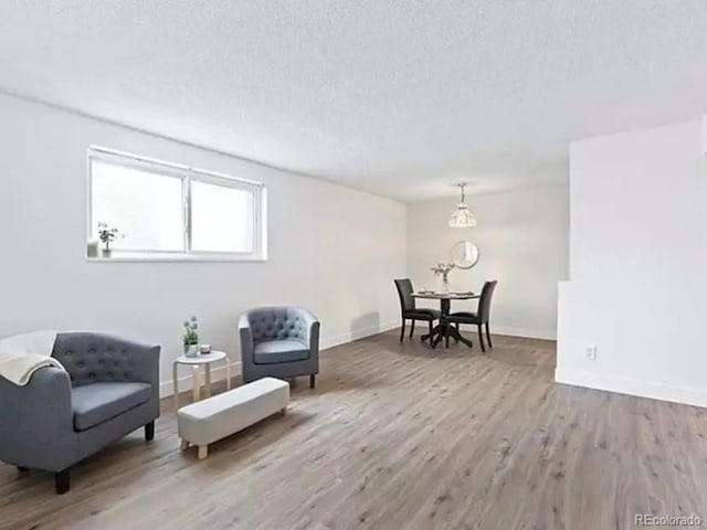 living area with hardwood / wood-style flooring and a textured ceiling