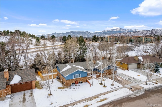 snowy aerial view featuring a mountain view