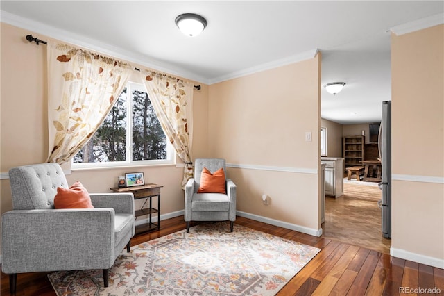 sitting room with ornamental molding and wood-type flooring