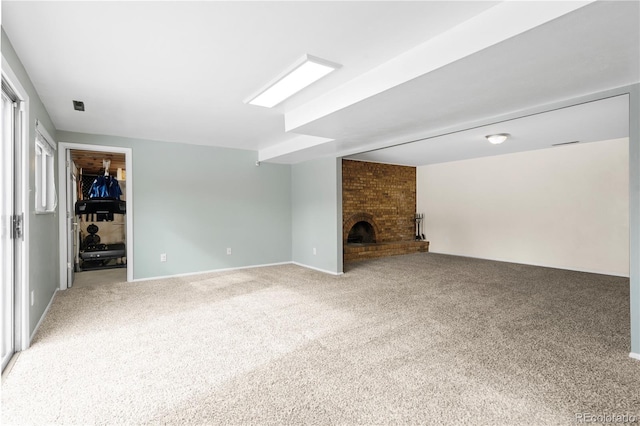 unfurnished living room featuring a fireplace and carpet flooring