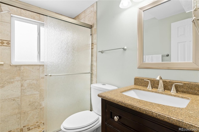 bathroom featuring vanity, toilet, and walk in shower