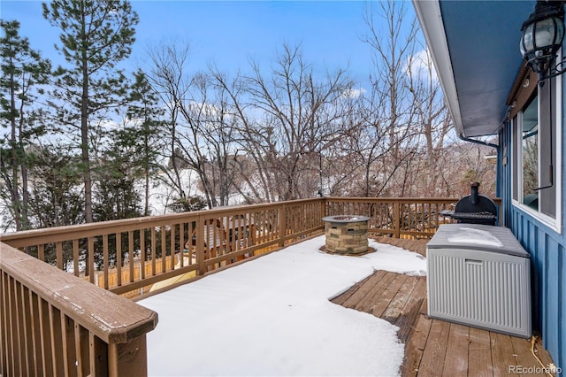 snow covered deck with a fire pit