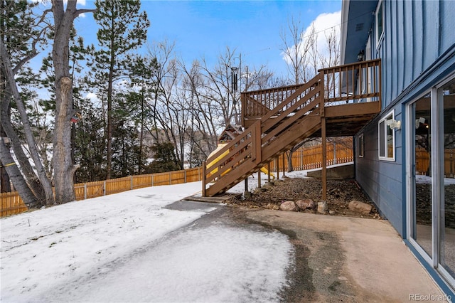 snowy yard with a deck