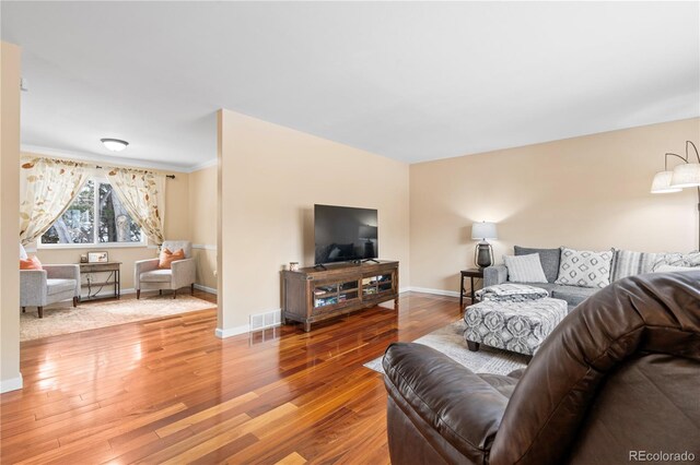 45 E Mikado Dr, Colorado Springs, CO 80919 - living room featuring wood finished floors, baseboards, and ornamental molding