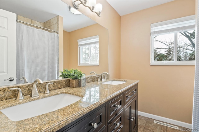 45 E Mikado Dr, Colorado Springs, CO 80919 - full bath featuring baseboards, double vanity, and a shower with curtain