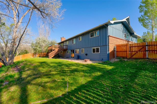 45 E Mikado Dr, Colorado Springs, CO 80919 - back of house with board and batten siding, a wooden deck, stairway, a chimney, and brick siding