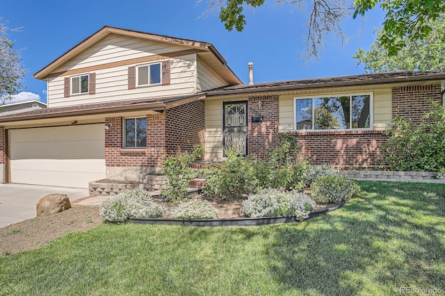 9270 Tennyson St, Westminster, CO 80031 - tri-level home with brick siding, concrete driveway, a front yard, and an attached garage