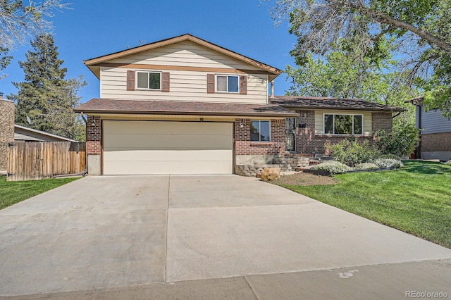 9270 Tennyson St, Westminster, CO 80031 - tri-level home featuring an attached garage, brick siding, and concrete driveway