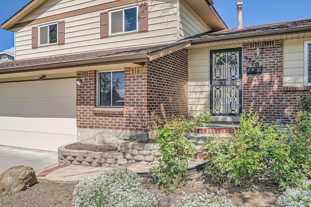 9270 Tennyson St, Westminster, CO 80031 - view of front facade featuring brick siding, a garage, a shingled roof, and concrete driveway