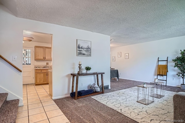 9270 Tennyson St, Westminster, CO 80031 - living room featuring stairway, a textured ceiling, light tile patterned floors, light colored carpet, and baseboards
