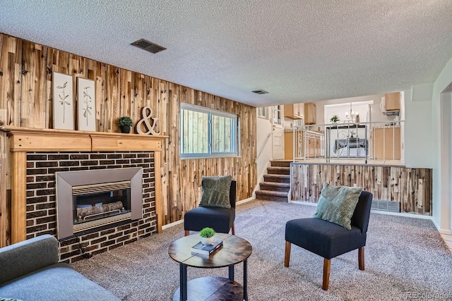 9270 Tennyson St, Westminster, CO 80031 - living room with wooden walls, a textured ceiling, stairs, a brick fireplace, and carpet floors