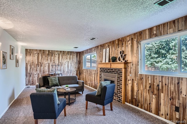 9270 Tennyson St, Westminster, CO 80031 - living room with wooden walls, a textured ceiling, a brick fireplace, baseboards, and carpet