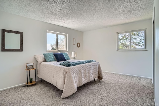 9270 Tennyson St, Westminster, CO 80031 - bedroom featuring light colored carpet, multiple windows, baseboards, and a textured ceiling