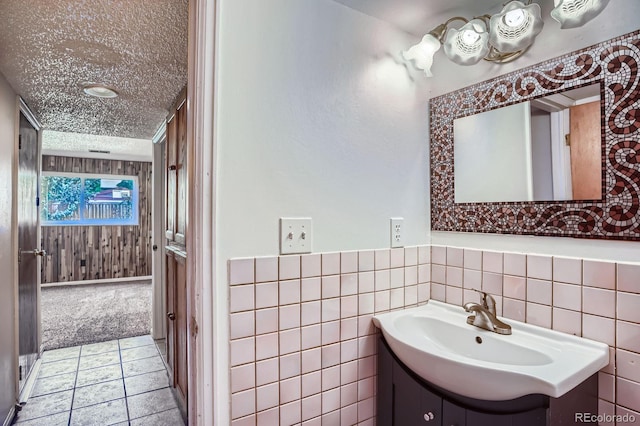 9270 Tennyson St, Westminster, CO 80031 - bathroom with a textured ceiling, vanity, and tile walls